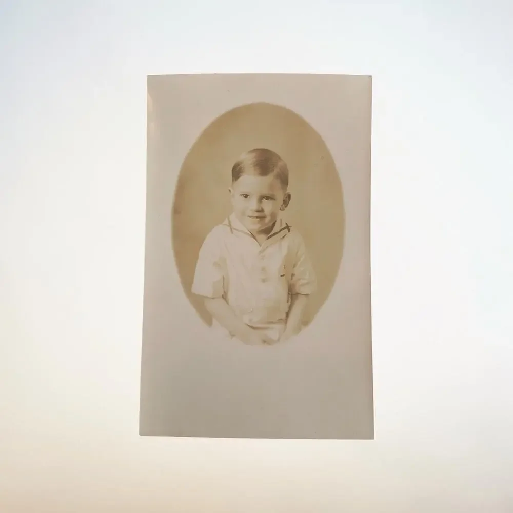vintage Real Photo Postcard (RPPC) depicting an oval-framed studio portrait of a